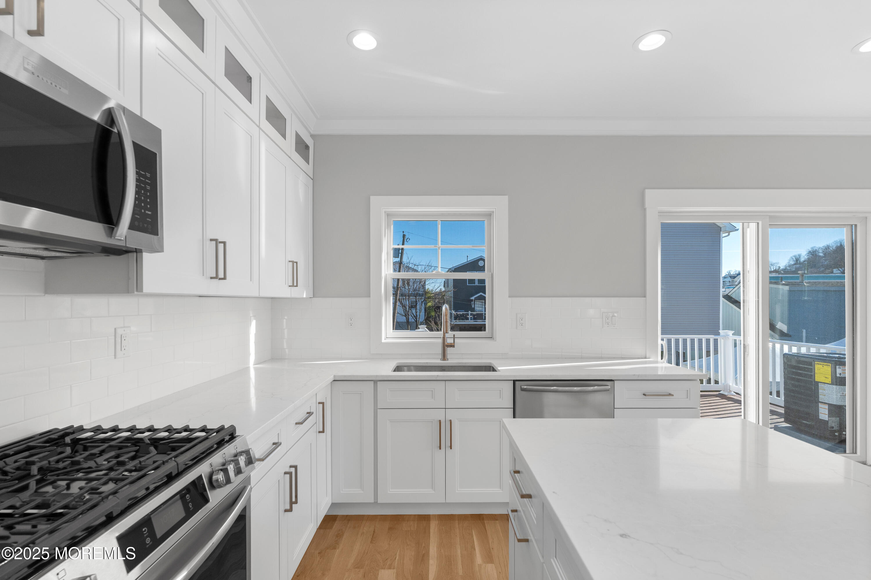Undisclosed Address Highlands, NJ 07732 - Photo 5 of 17 a kitchen with stainless steel appliances a stove a sink and a microwave