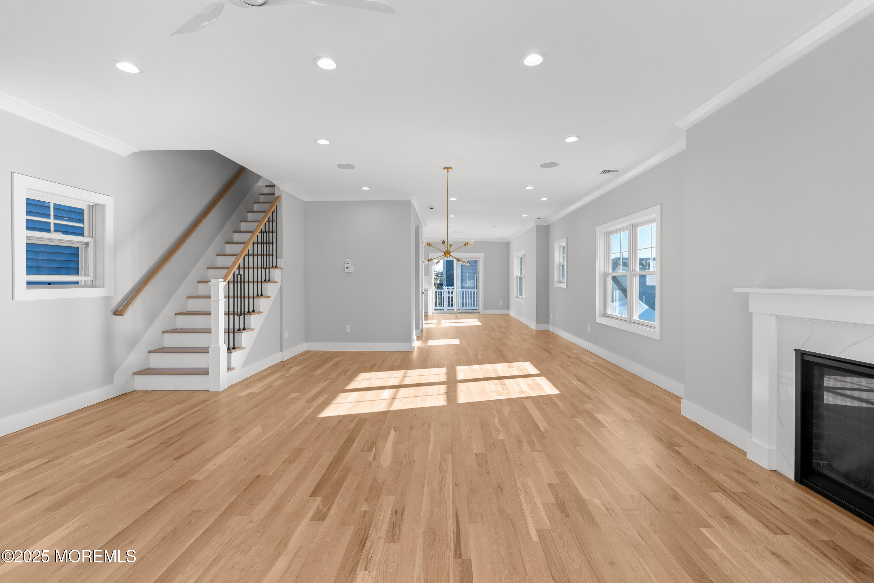 Undisclosed Address Highlands, NJ 07732 - Photo 8 of 17 a view of an empty room with wooden floor and a fireplace