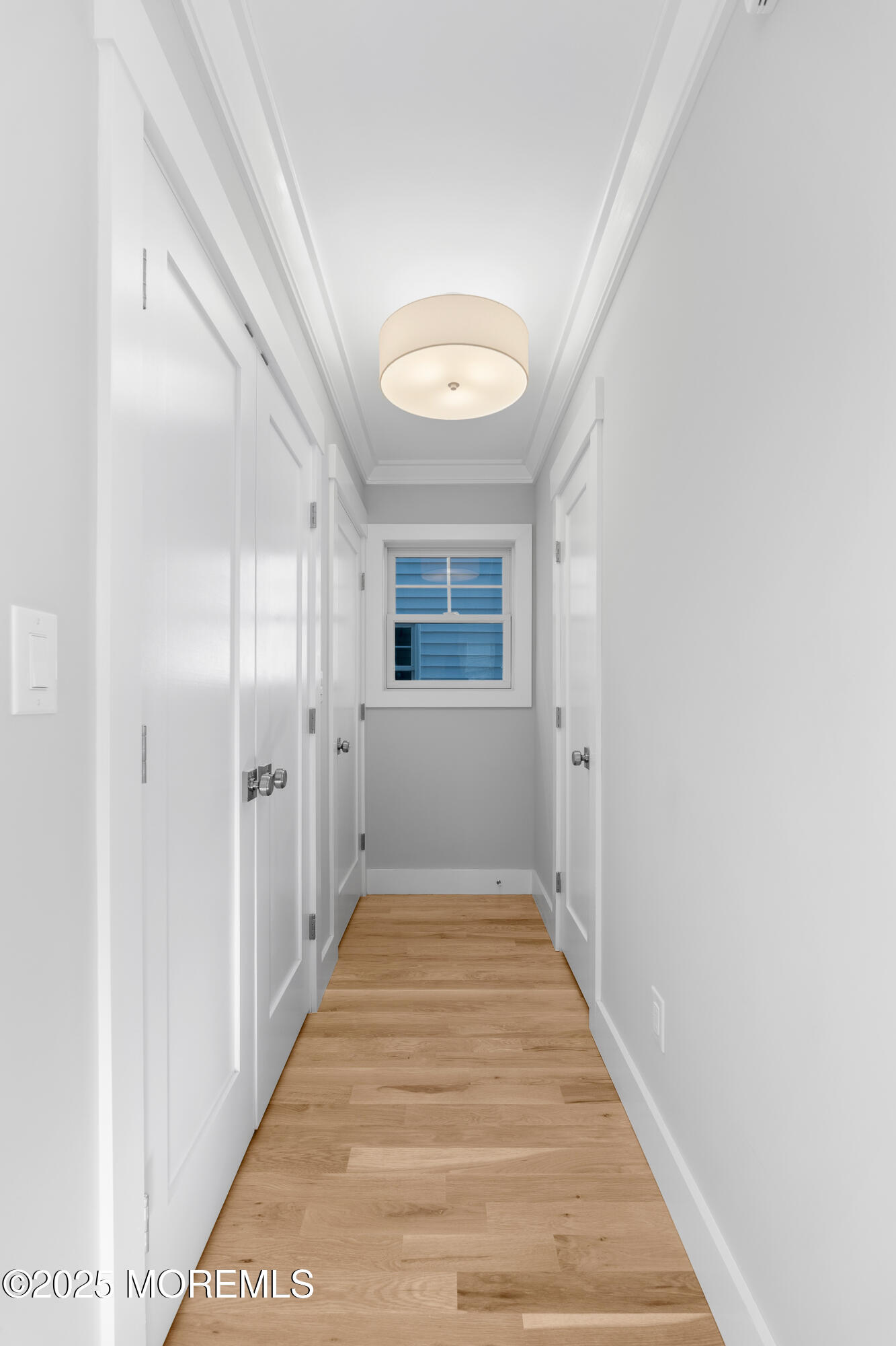 Undisclosed Address Highlands, NJ 07732 - Photo 10 of 17 a view of a hallway with wooden floor and a bathroom