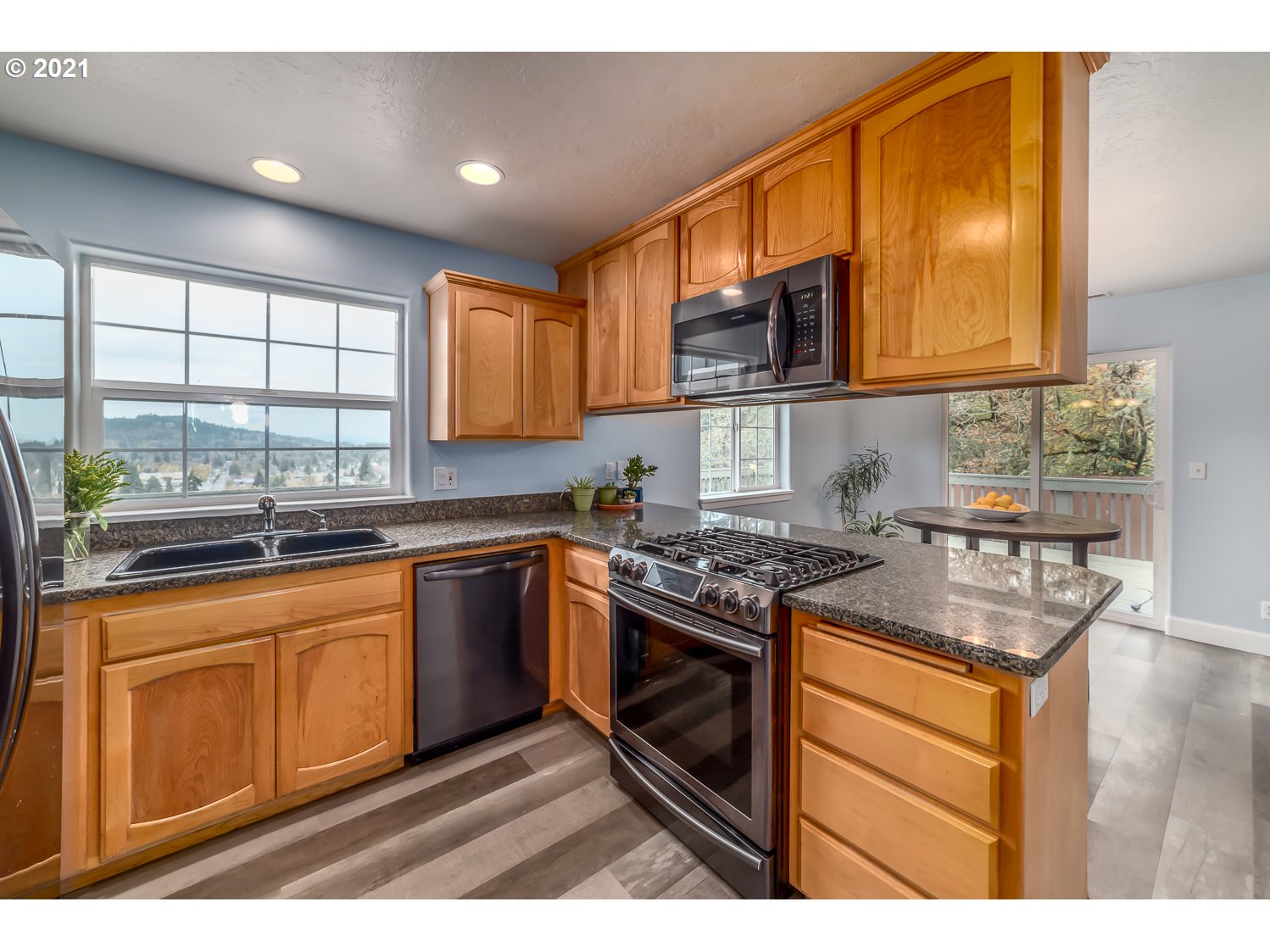 870 Kristen Way Cottage Grove, OR 97424 - Photo 13 of 31 a kitchen with stainless steel appliances granite countertop a stove a sink and a microwave