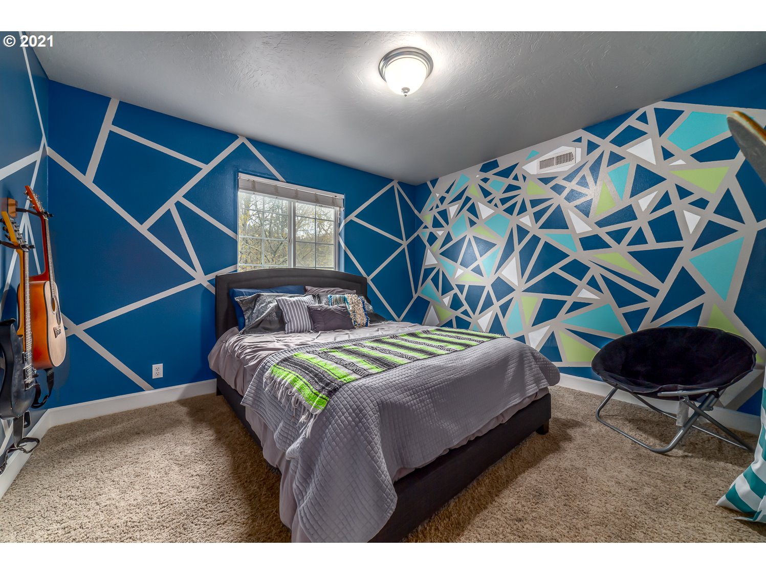870 Kristen Way Cottage Grove, OR 97424 - Photo 23 of 31 a bedroom with a bed and a painting on the wall