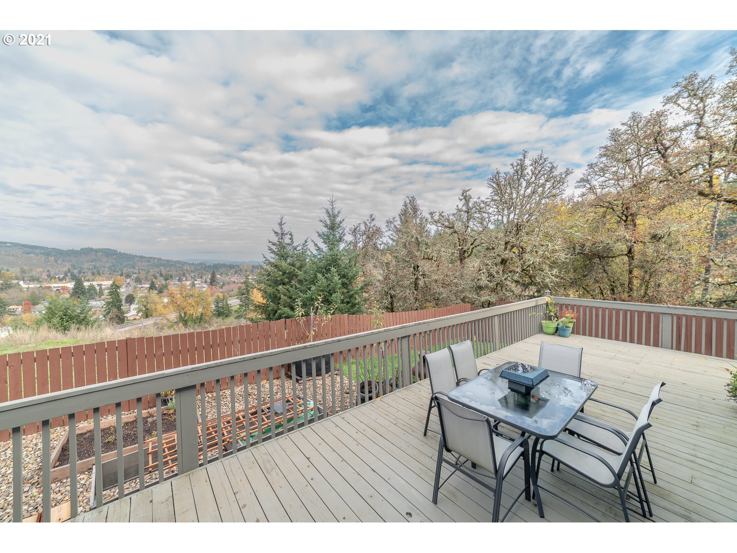 870 Kristen Way Cottage Grove, OR 97424 - Photo 4 of 31 a view of a balcony with mountain view and wooden floor