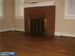 109 West Upper Ferry Road Trenton, NJ 08628 - Photo 4 of 7 Living room with fireplace and hardwood flooring.
