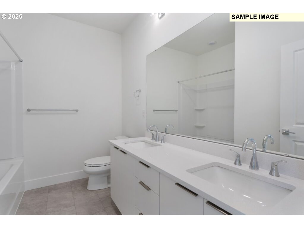 6420 Northwest Olympic Lane, Unit L47 Camas, WA 98607 - Photo 15 of 24 a bathroom with a granite countertop sink a toilet and a mirror
