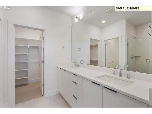 a bathroom with a sink double vanity and a mirror