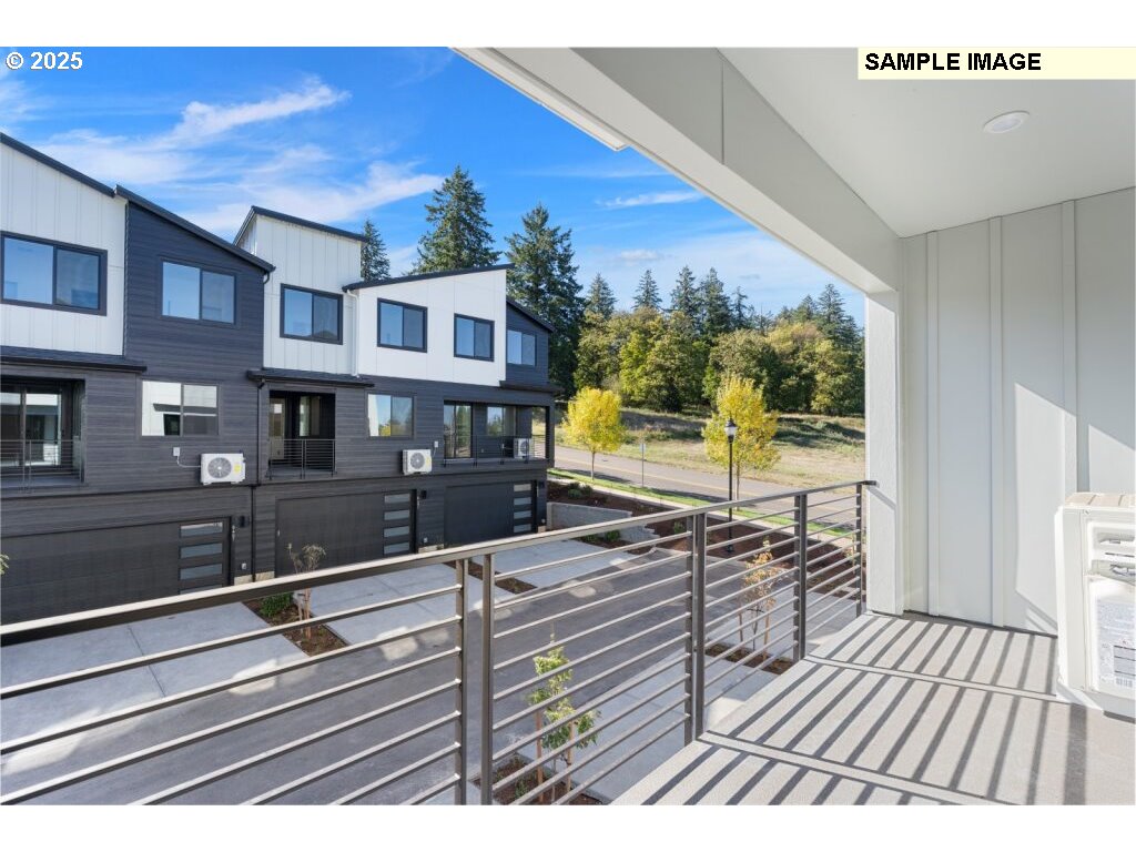 6420 Northwest Olympic Lane, Unit L47 Camas, WA 98607 - Photo 22 of 24 a view of a balcony with wooden floor and iron stairs