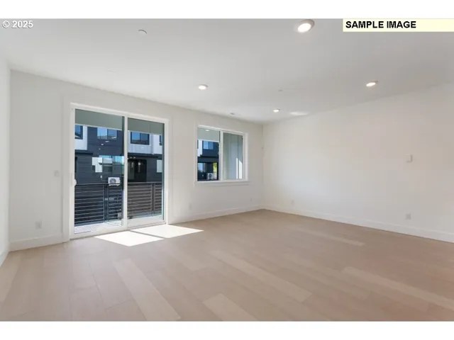 a view of an empty room with closet and window