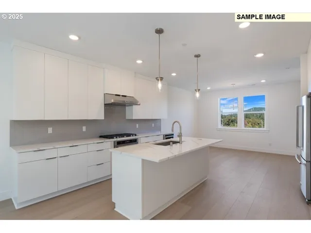 a kitchen with a sink a stove a microwave and island