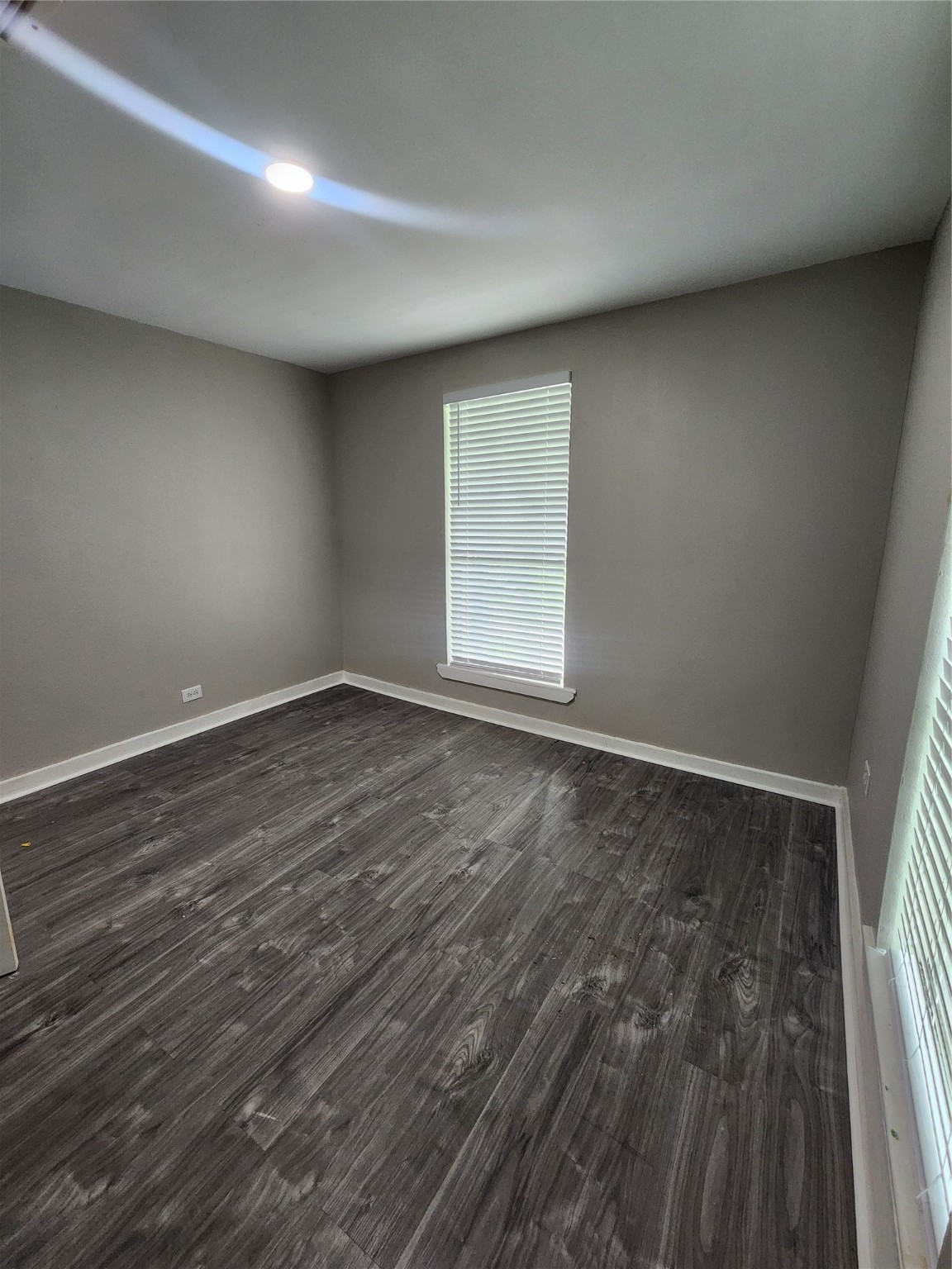 6203 Hoffman Street Houston, TX 77028 - Photo 14 of 19 an empty room with wooden floor and windows