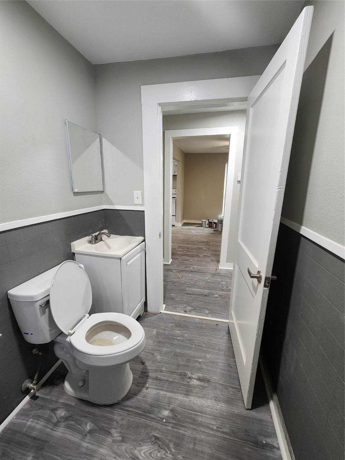 6203 Hoffman Street Houston, TX 77028 - Photo 17 of 19 a white toilet sitting next to a bathroom sink