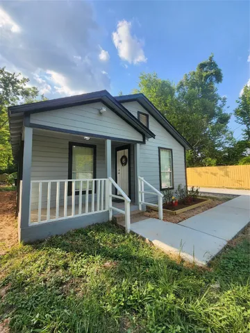a view of a house with a yard and sitting area