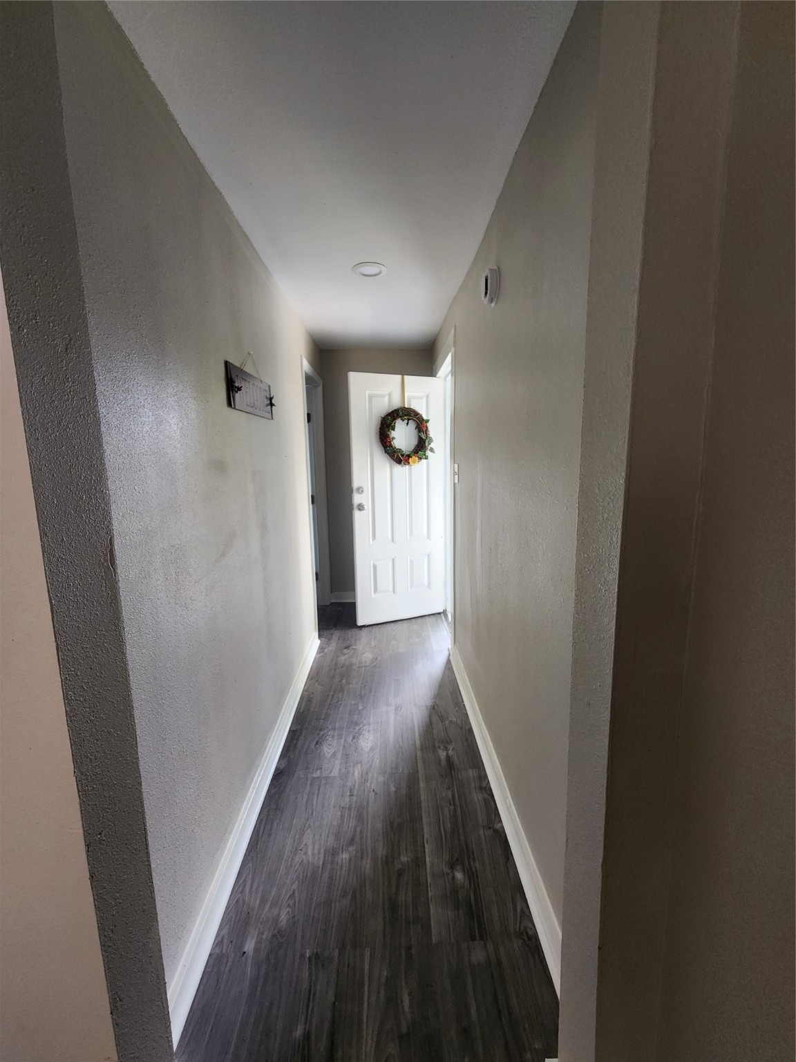 6203 Hoffman Street Houston, TX 77028 - Photo 4 of 19 a view of a hallway with wooden floor