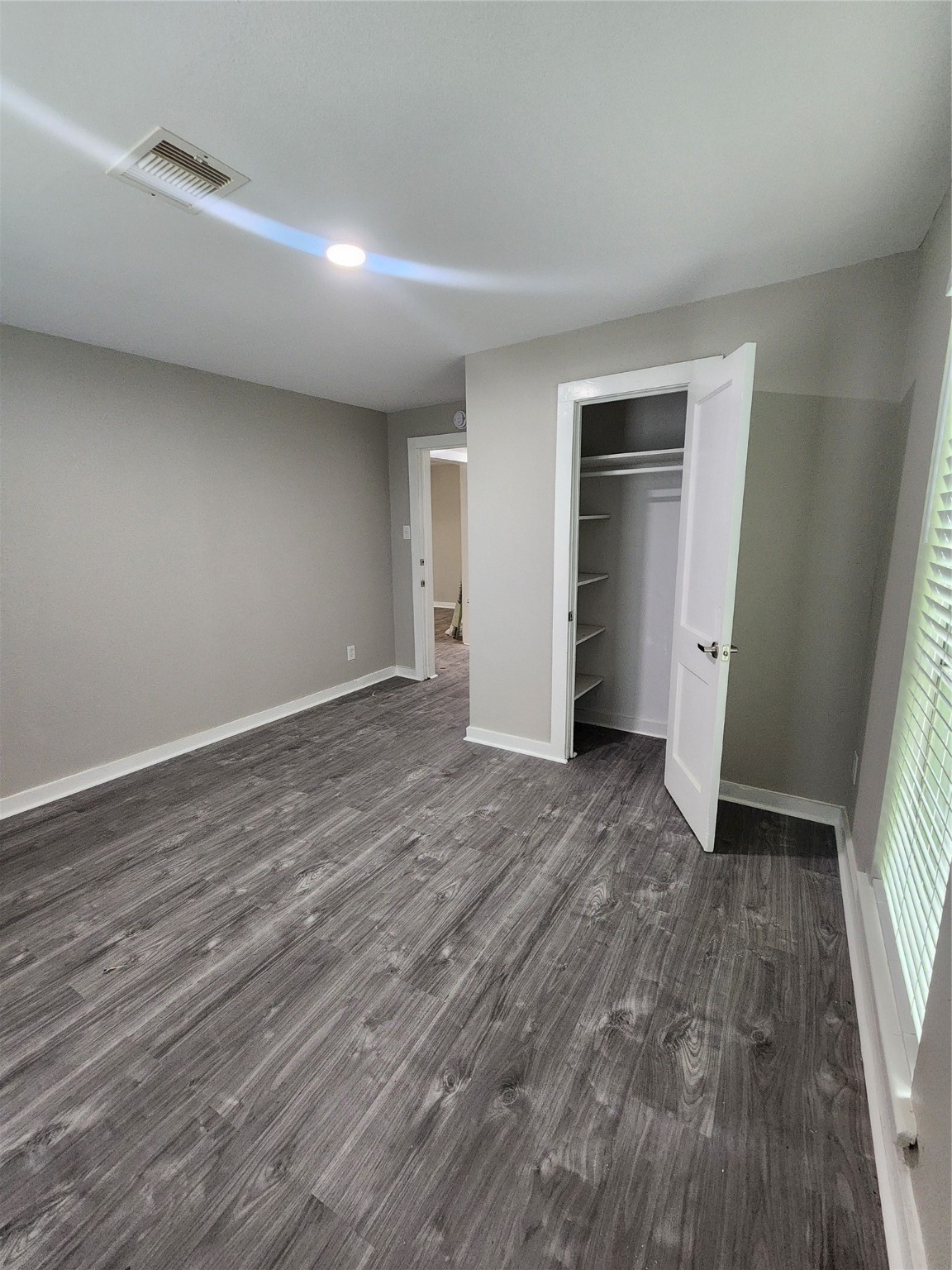 6203 Hoffman Street Houston, TX 77028 - Photo 10 of 19 wooden floor in an empty room with a window