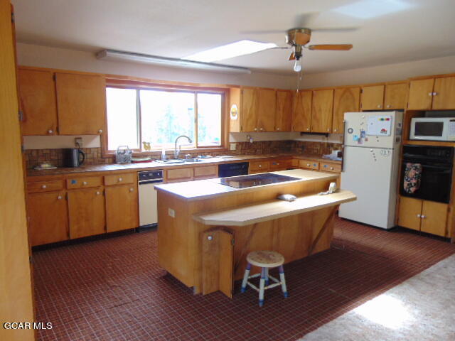 446 County Road 86 Tabernash, CO 80478 - Photo 12 of 36 a kitchen with a table chairs refrigerator and cabinets