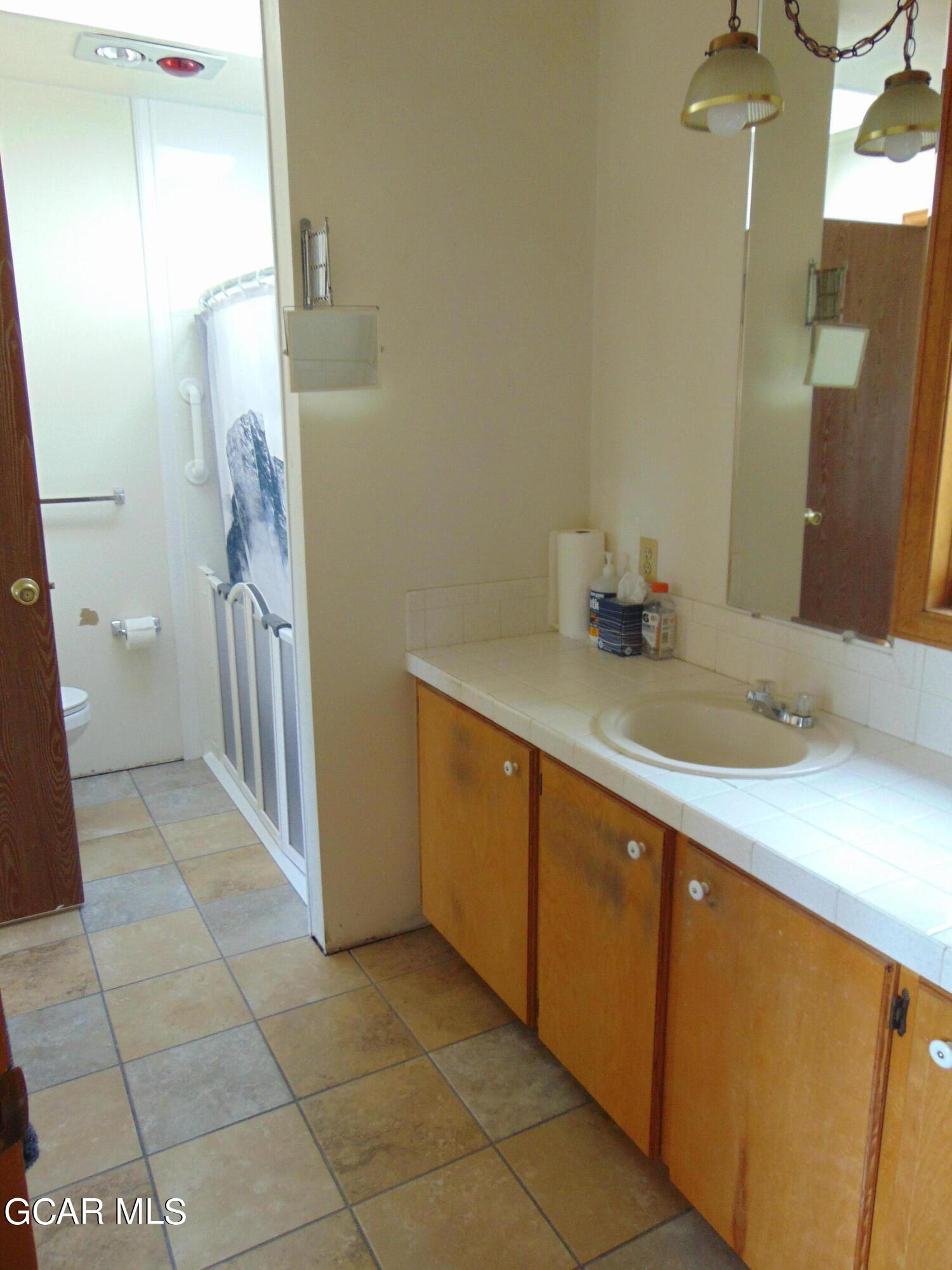 446 County Road 86 Tabernash, CO 80478 - Photo 23 of 36 a bathroom with a sink a toilet and a mirror