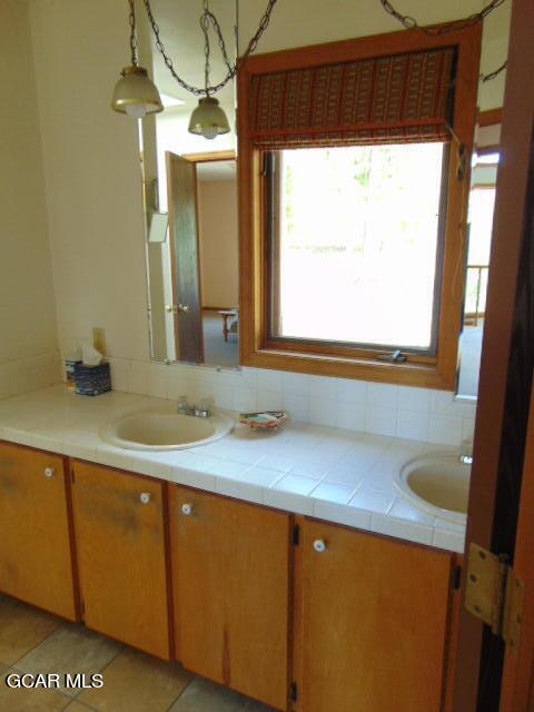 446 County Road 86 Tabernash, CO 80478 - Photo 24 of 36 a bathroom with a sink and a mirror