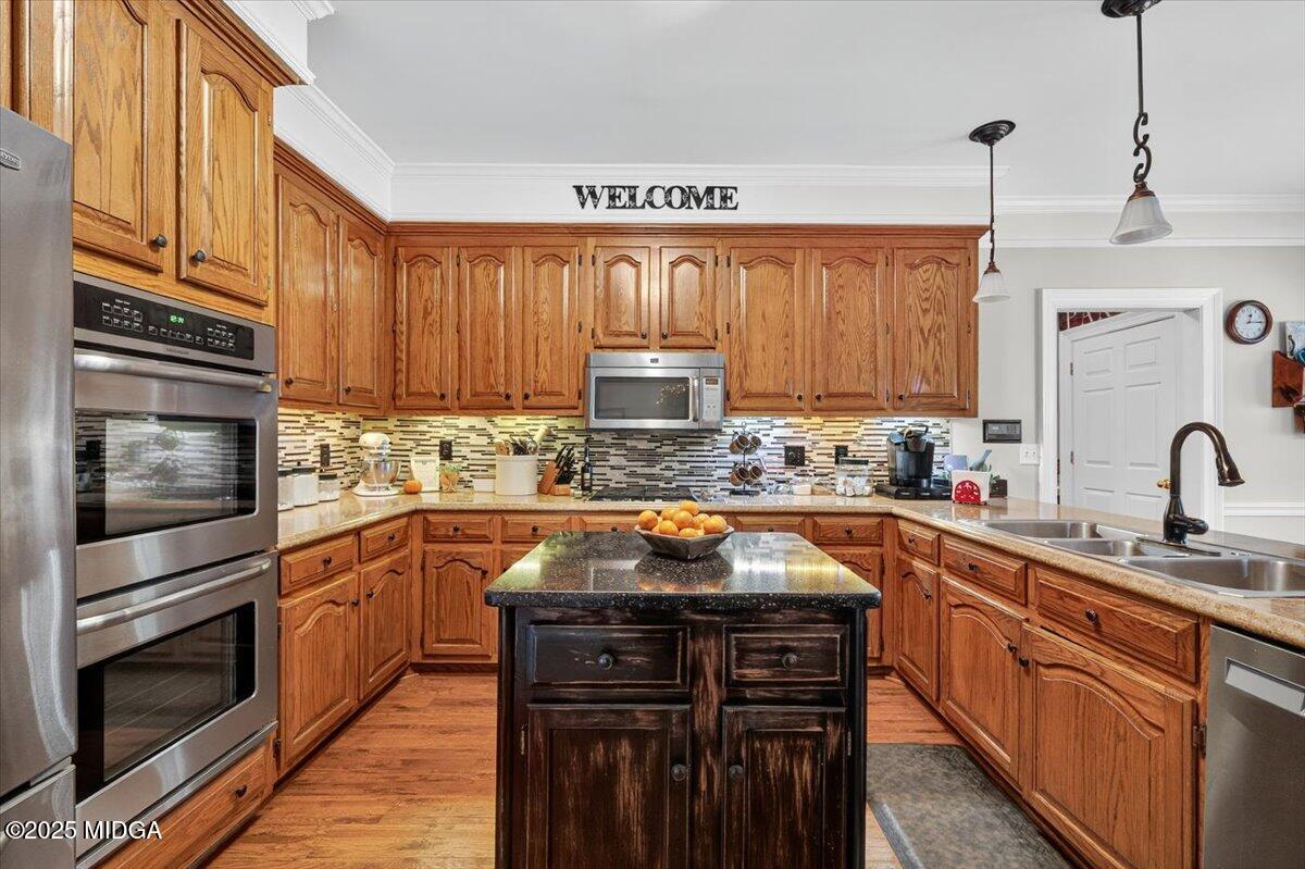 5771 Rogers Road Lizella, GA 31052 - Photo 16 of 74 a kitchen with stainless steel appliances a stove sink microwave and cabinets