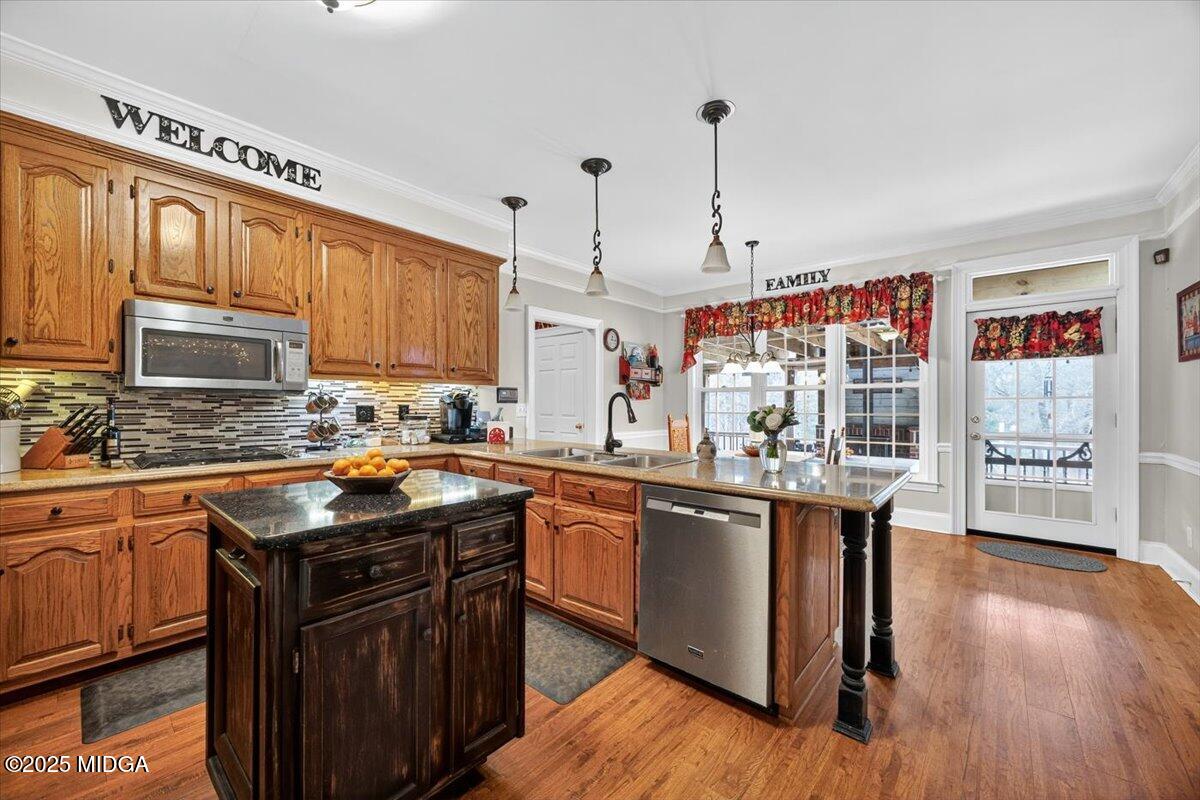 5771 Rogers Road Lizella, GA 31052 - Photo 17 of 74 a kitchen with stainless steel appliances granite countertop a sink stove and wooden cabinets
