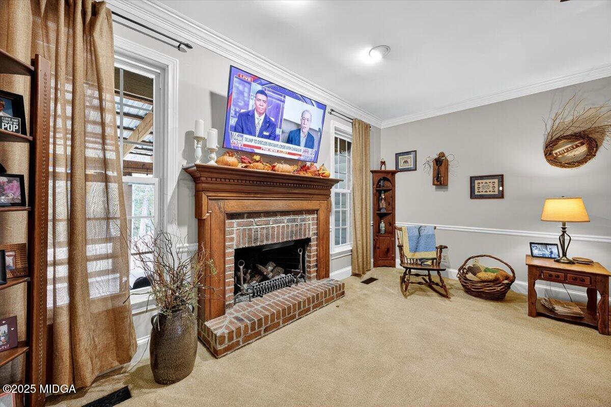 5771 Rogers Road Lizella, GA 31052 - Photo 18 of 74 a living room with furniture a flat screen tv and a fireplace