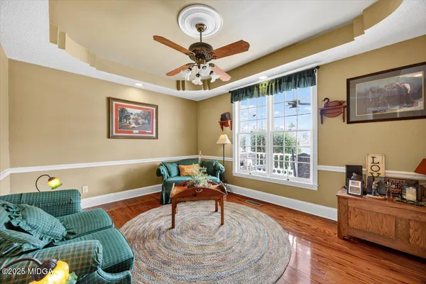 a bedroom with two beds and a chandelier
