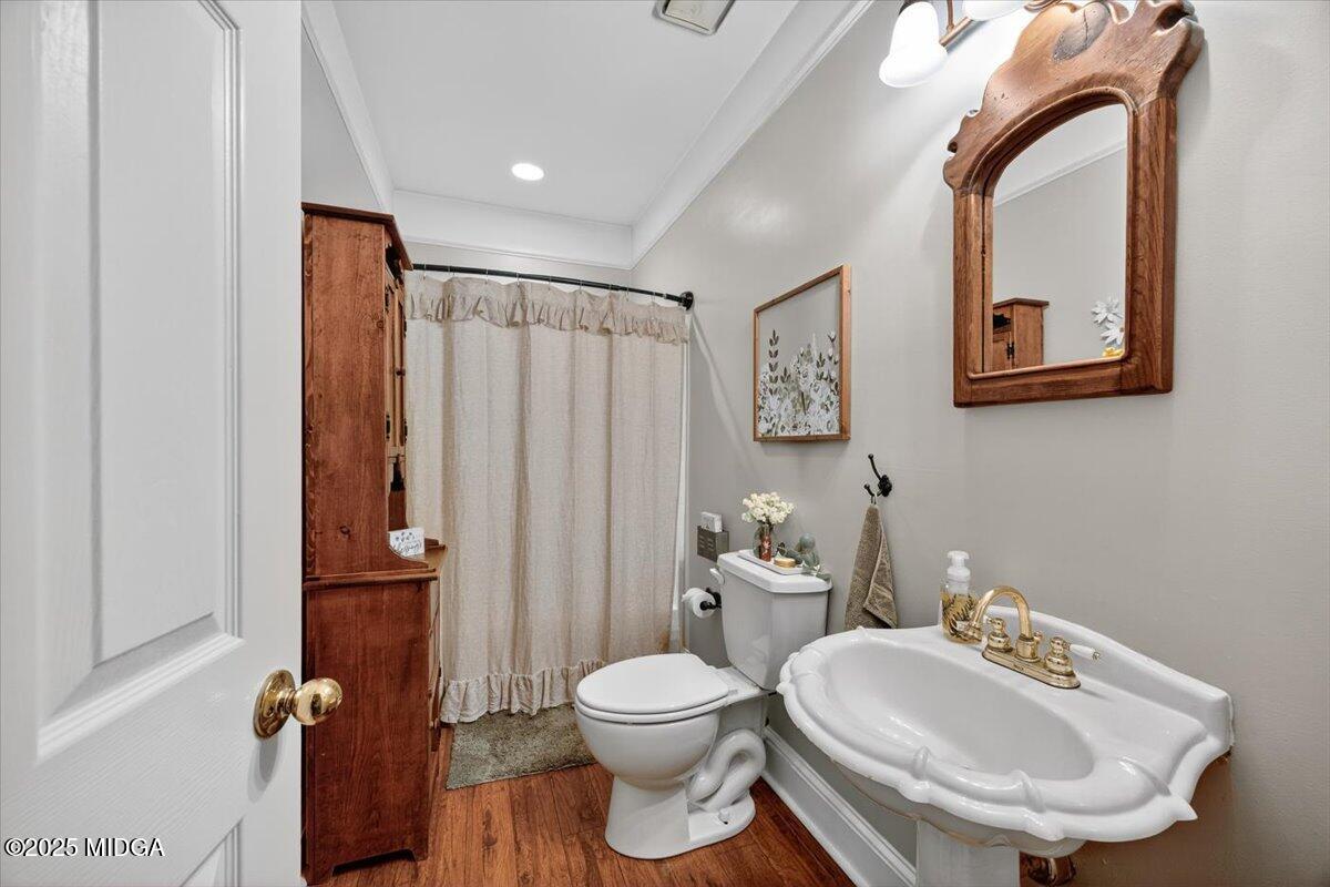 5771 Rogers Road Lizella, GA 31052 - Photo 26 of 74 a bathroom with a toilet a sink and mirror