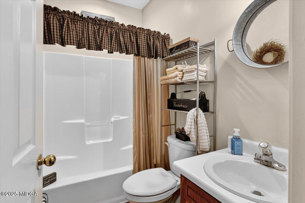 5771 Rogers Road Lizella, GA 31052 - Photo 29 of 74 a bathroom with a sink toilet and shower