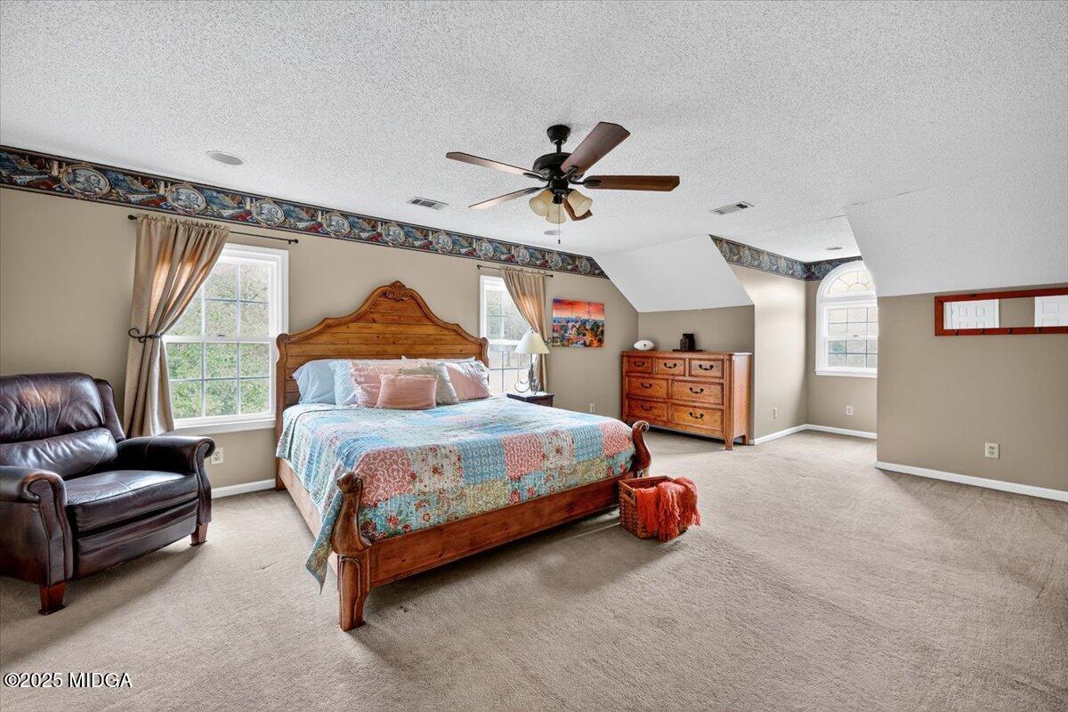 5771 Rogers Road Lizella, GA 31052 - Photo 32 of 74 a bedroom with a bed couch and window