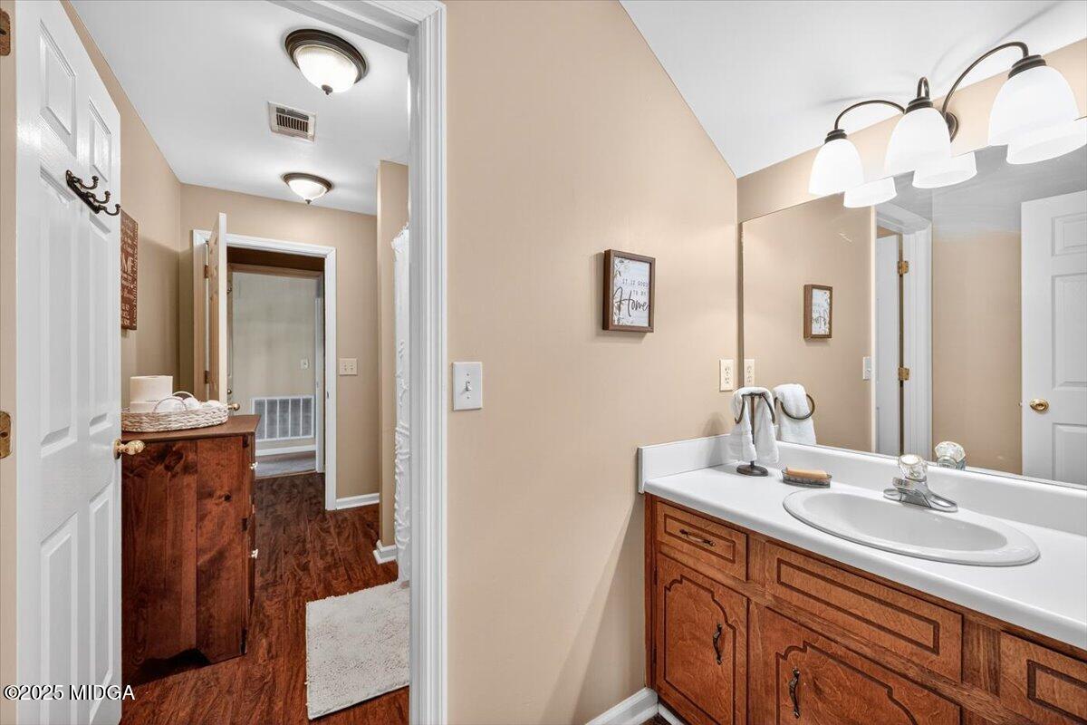 5771 Rogers Road Lizella, GA 31052 - Photo 36 of 74 a bathroom with a sink vanity and a mirror