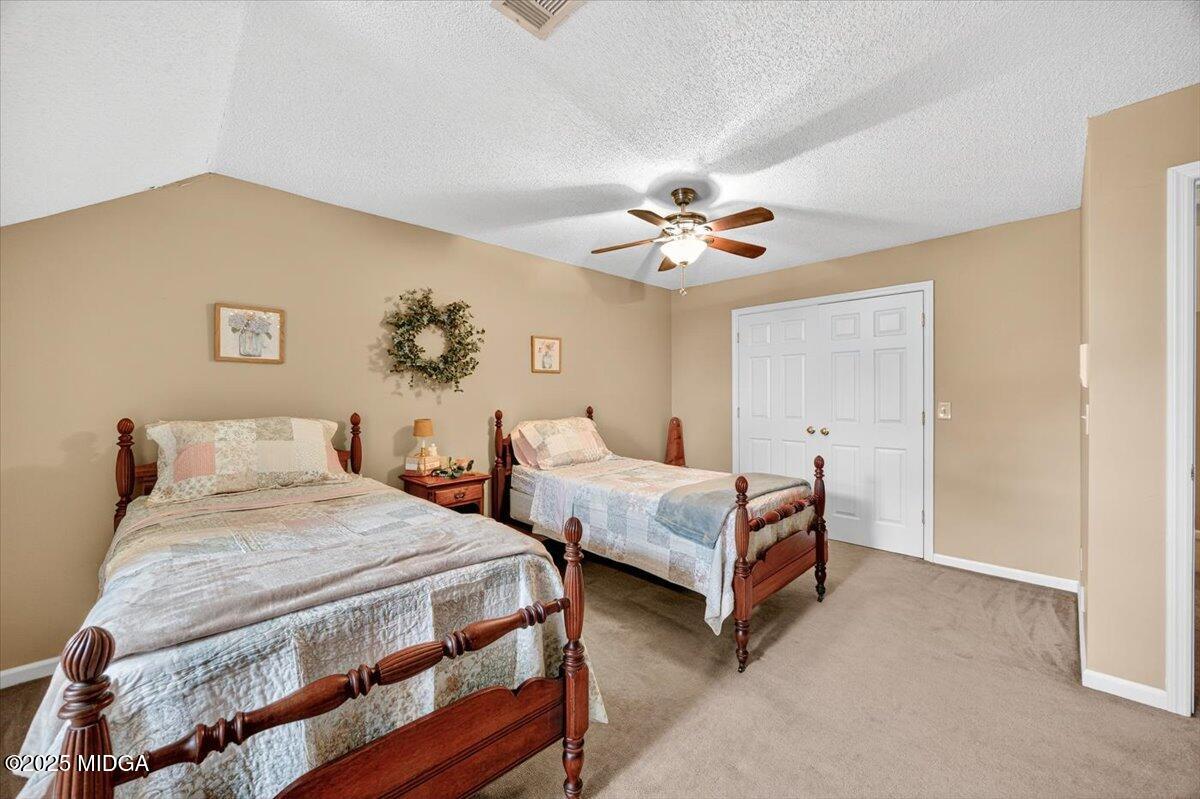 5771 Rogers Road Lizella, GA 31052 - Photo 38 of 74 a bedroom with two beds and a chandelier