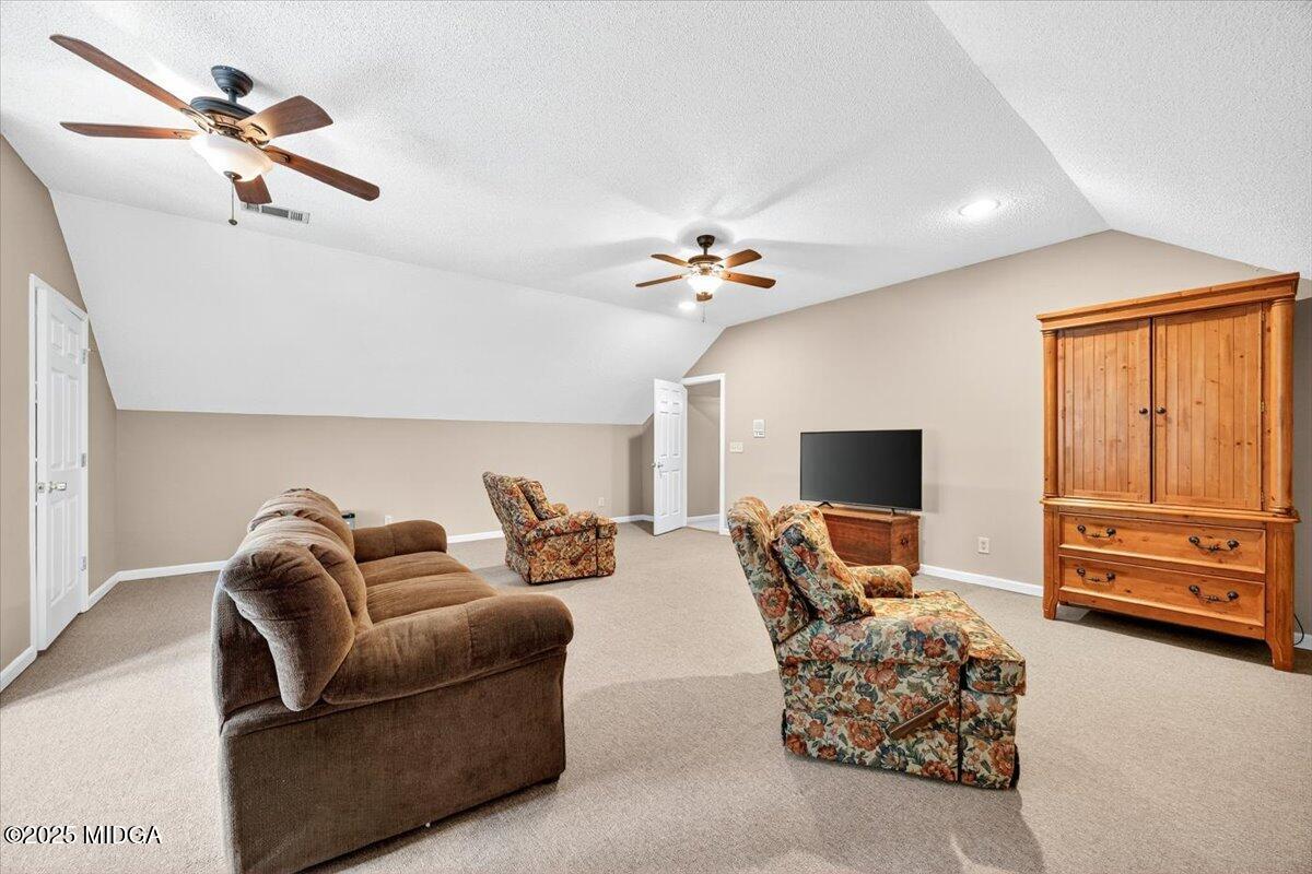 5771 Rogers Road Lizella, GA 31052 - Photo 42 of 74 a living room with furniture and a flat screen tv
