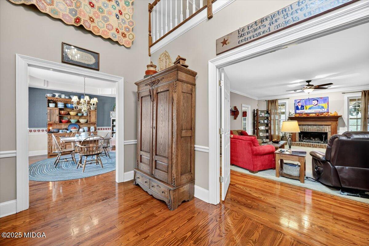 5771 Rogers Road Lizella, GA 31052 - Photo 43 of 74 a living room with furniture a fireplace and a dining table with wooden floor