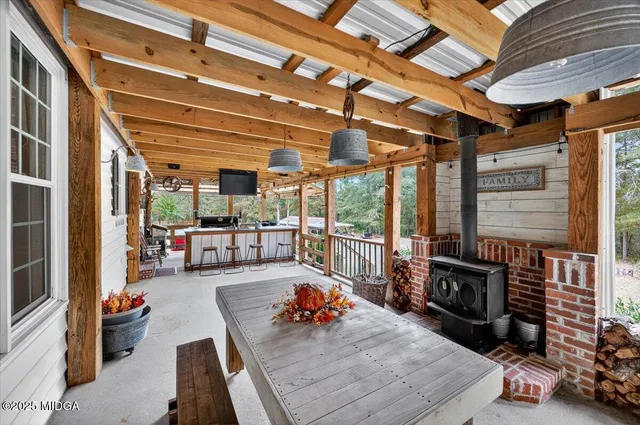 an aerial view of residential houses with outdoor space and trees