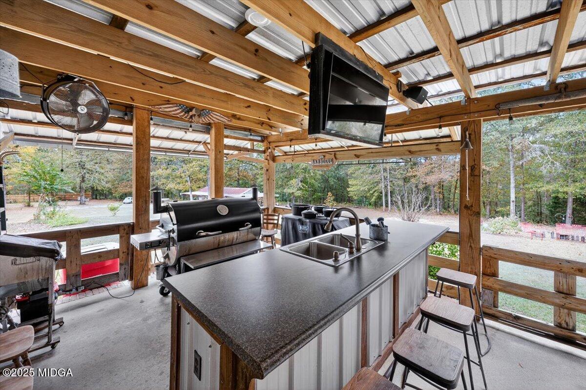 5771 Rogers Road Lizella, GA 31052 - Photo 49 of 74 a kitchen with a table chairs and a barbeque