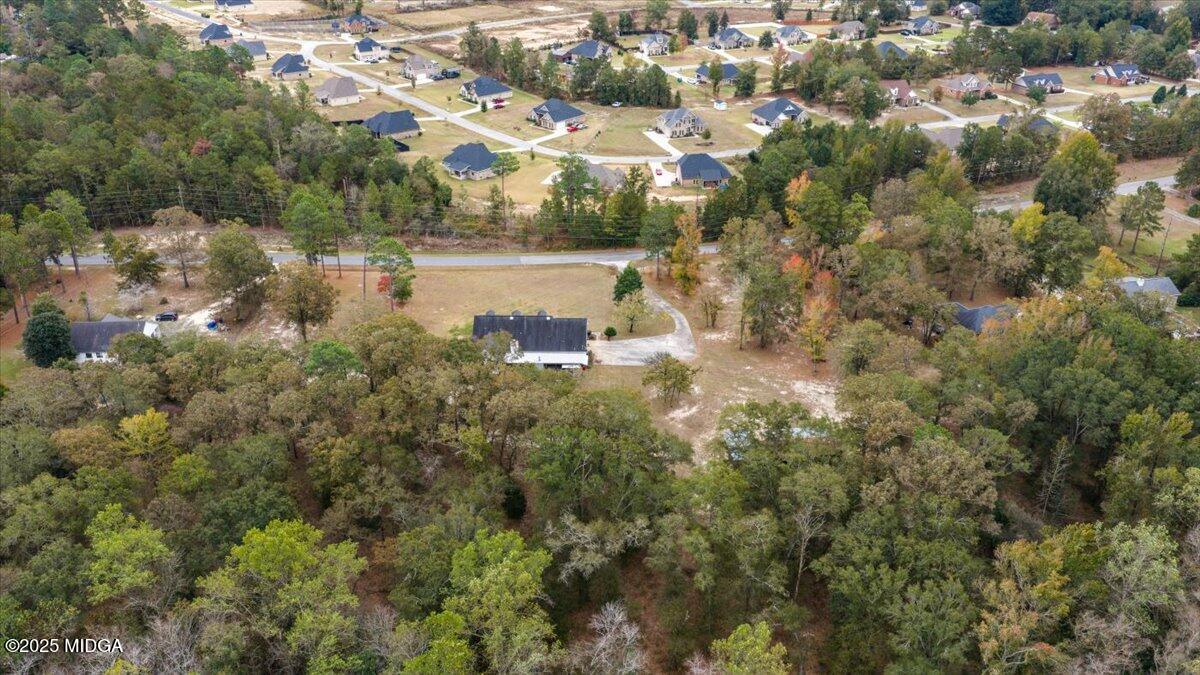 5771 Rogers Road Lizella, GA 31052 - Photo 70 of 74 an aerial view of residential houses with outdoor space and trees