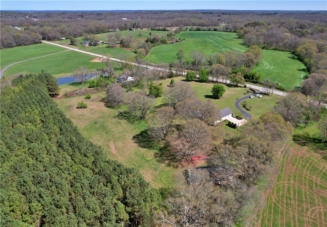 7893 Athens Road Carnesville, GA 30521 - Photo 49 of 50 Expansive acreage offering a tranquil escape with a blend of wooded and open fields.