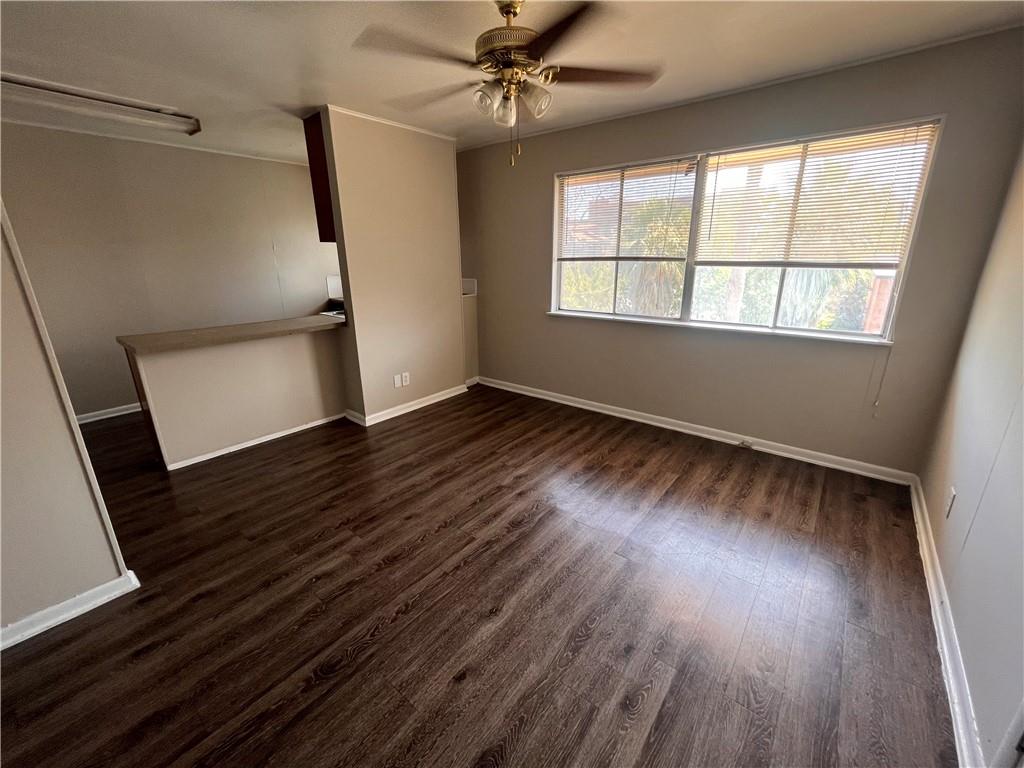3304 Red River Street, Unit 204 Austin, TX 78705 - Photo 2 of 17 an empty room with wooden floor fan and windows