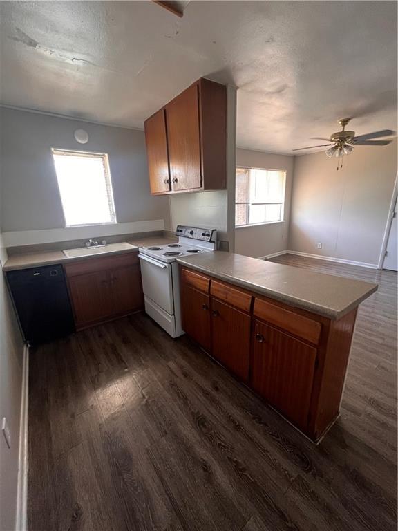 3304 Red River Street, Unit 204 Austin, TX 78705 - Photo 5 of 17 a kitchen with granite countertop a sink a stove cabinets and wooden floor