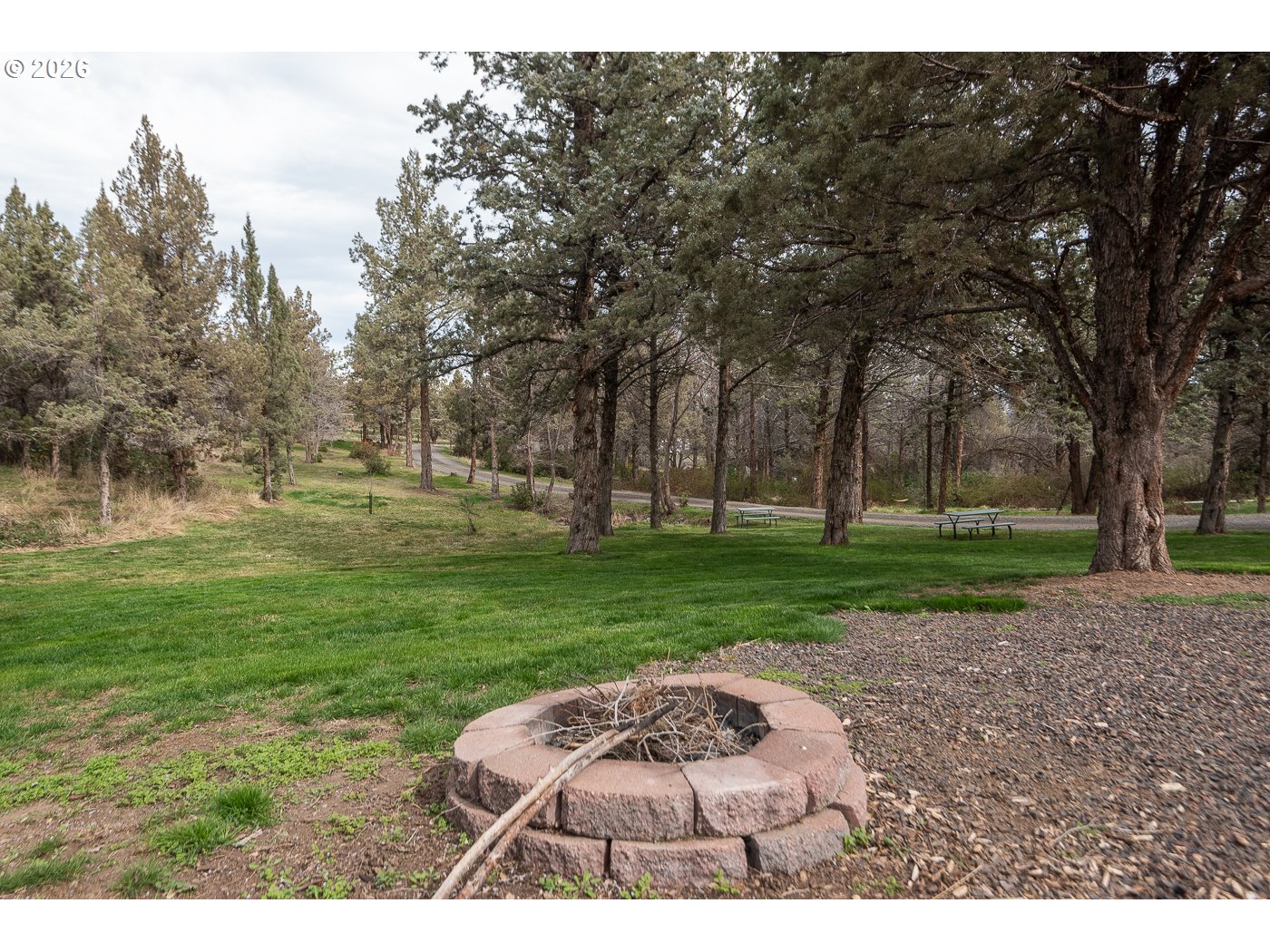 905 Southwest Burns Lane Madras, OR 97741 - Photo 9 of 40 a backyard of a house with a garden and outdoor seating
