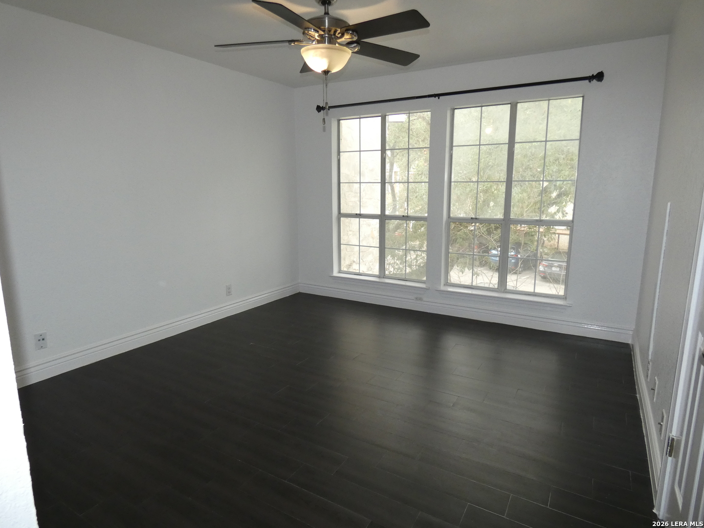 14745 Babcock Road, Unit 610 San Antonio, TX 78249 - Photo 11 of 32 an empty room with wooden floor and windows
