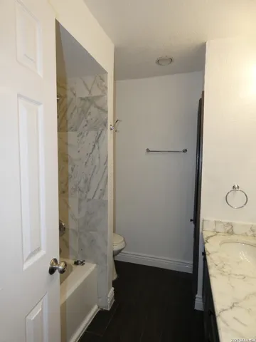 a bathroom with a granite countertop sink
