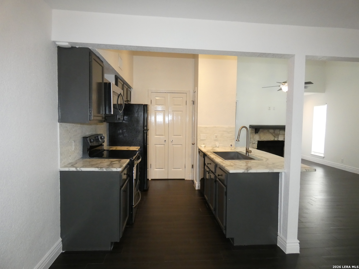 14745 Babcock Road, Unit 610 San Antonio, TX 78249 - Photo 4 of 32 a kitchen with a stove top oven sink and a refrigerator