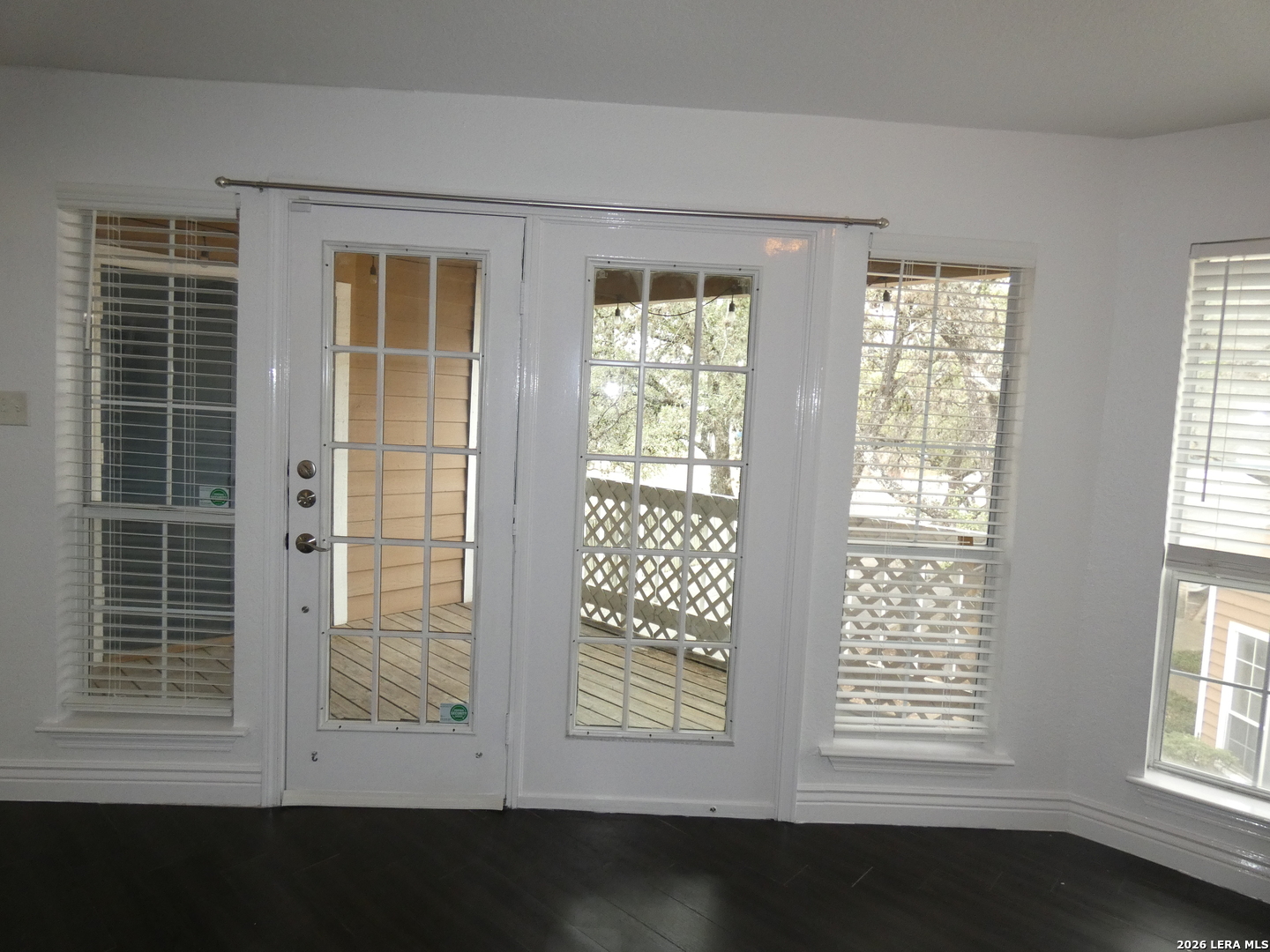 14745 Babcock Road, Unit 610 San Antonio, TX 78249 - Photo 7 of 32 a view of an empty room with wooden floor and a window