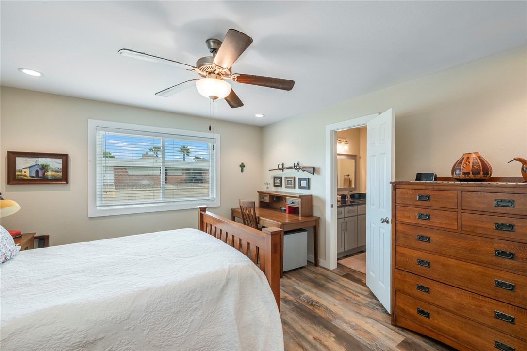 230 Cut-Off Road, Unit 101 Port Aransas, TX 78373 - Photo 17 of 30 a bedroom with a bed and wooden floor