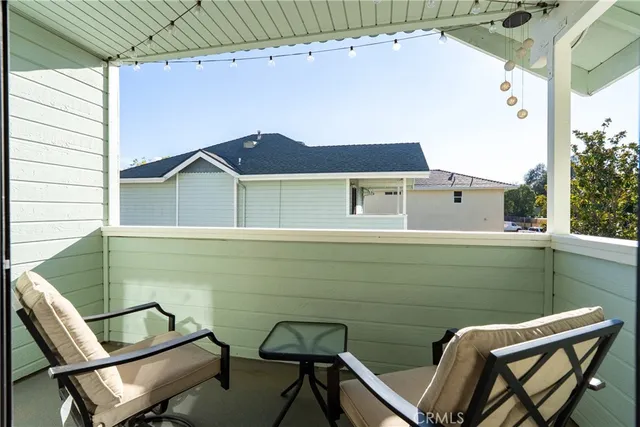 a balcony with table and chairs