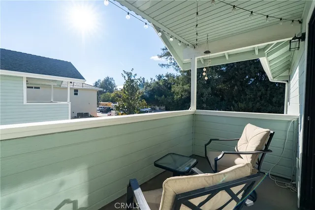 a view of a chairs and table in the balcony