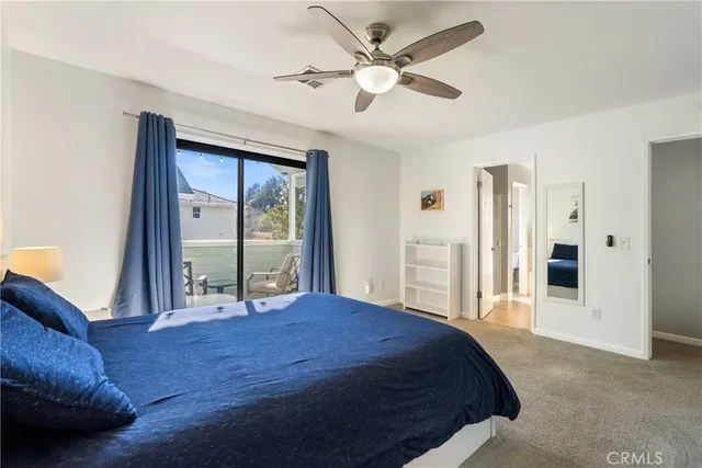 a bedroom with a large bed closet and chandelier