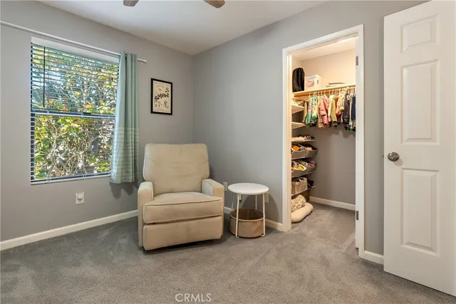 a living room with furniture a window and a walk in closet