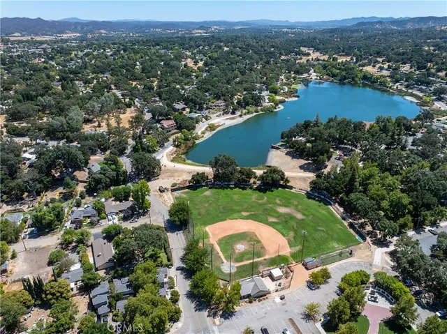 an aerial view of residential houses with outdoor space and river