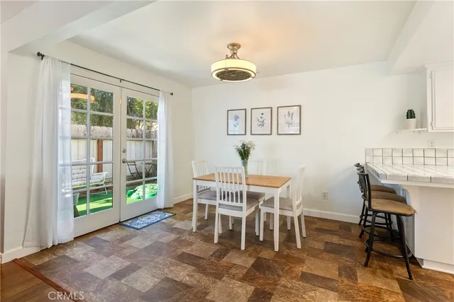 a view of a dining room with furniture and a window
