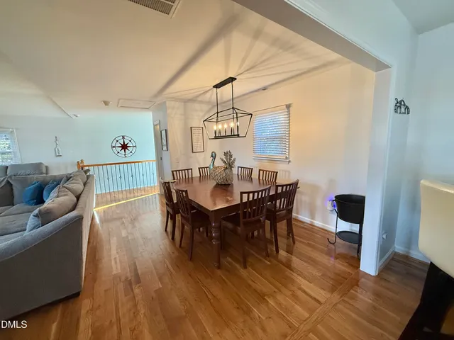 a view of a dining area with furniture and a chandelier